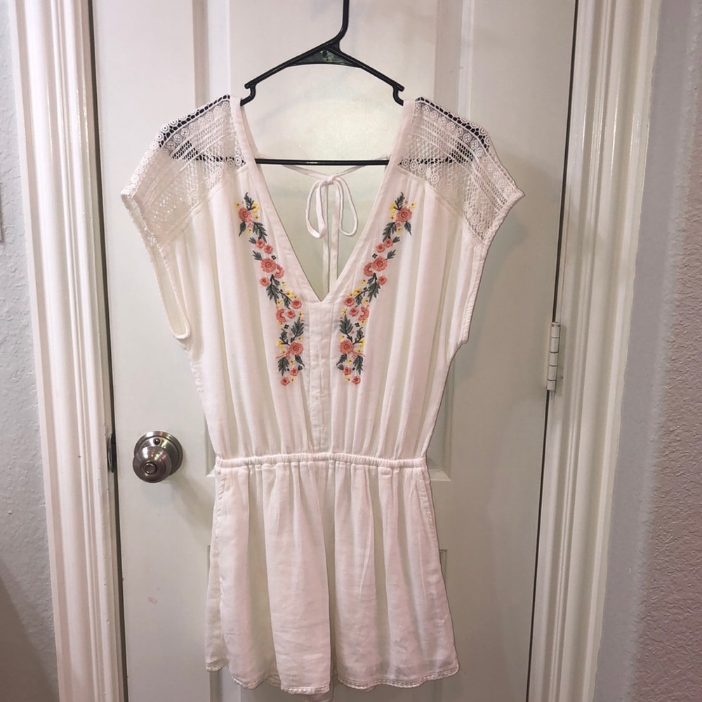 A pretty white romper with a tie back